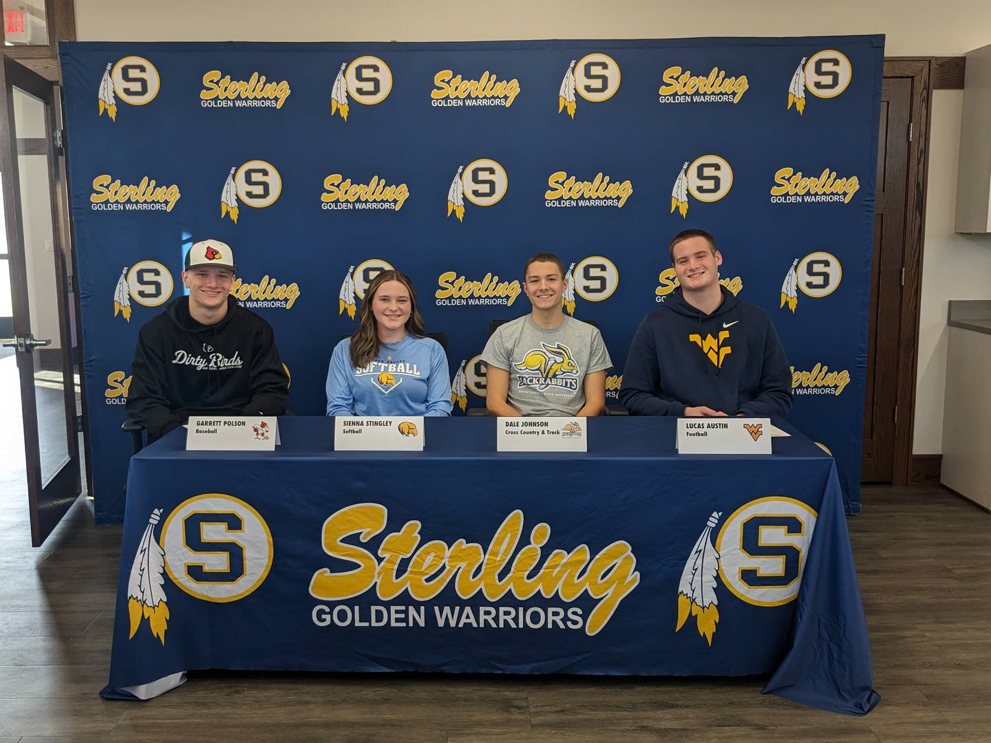 Left to right: Sterling seniors Garrett Polson, Sienna Stingley, Dale Johnson and Lucas Austin sign to play college athletics at the Sterling Schools Foundation Building on Dec. 20, 2023.