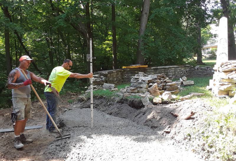 John Anderson (green shirt) and Bobby Harden of Anderson Concrete finish the concrete footings on the southwest wall of the Wallace-Dickey Cemetery (not shown, Jade Gualandi of Western Sand and Gravel).