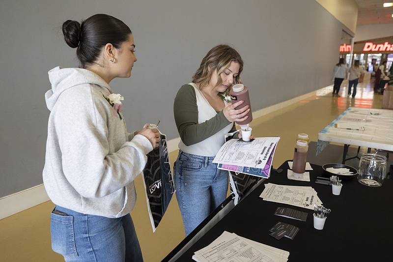 Calista Lopez (left) of Sterling and Olivia Garza-McCombs of Rock Falls sample the goods from Back Road Bar-B-Q Sunday, Feb. 2, 2025, at the Sauk Valley Wedding Expo in Sterling.