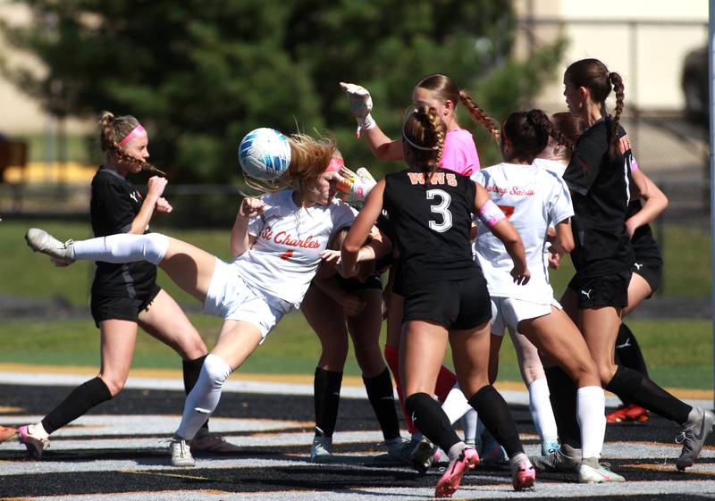 St. Charles East's Presley Kannaka gets tangled up after a goal kick during a game against Wheaton Warrenville South on Friday, May 16, 2025 in Wheaton.