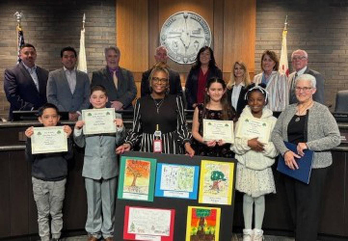 Four of the winners in the Arbor Day Poster Contest at Edna Keith Elementary School in Joliet pose with the City Council on April 15, 2025.