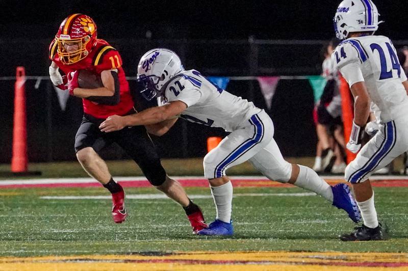 Batavia’s Brett Berggren (11) runs after the catch against St. Charles North's Wyatt Brandt (22) during a football game at Batavia High School on Friday, Sep 20, 2024.