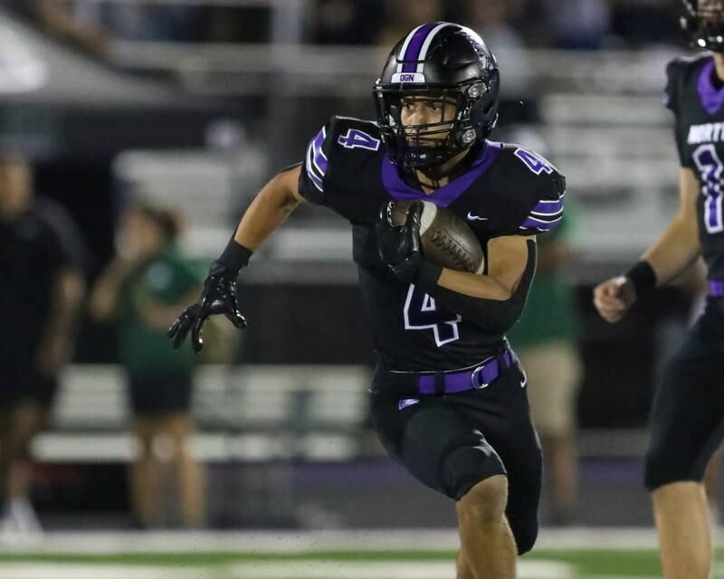 Downers Grove North's Caden Chiarelli (4) runs with the ball during a football game between Glenbard West at Downers Grove North on Friday, Sept 13th, 2024  in Downers Grove.