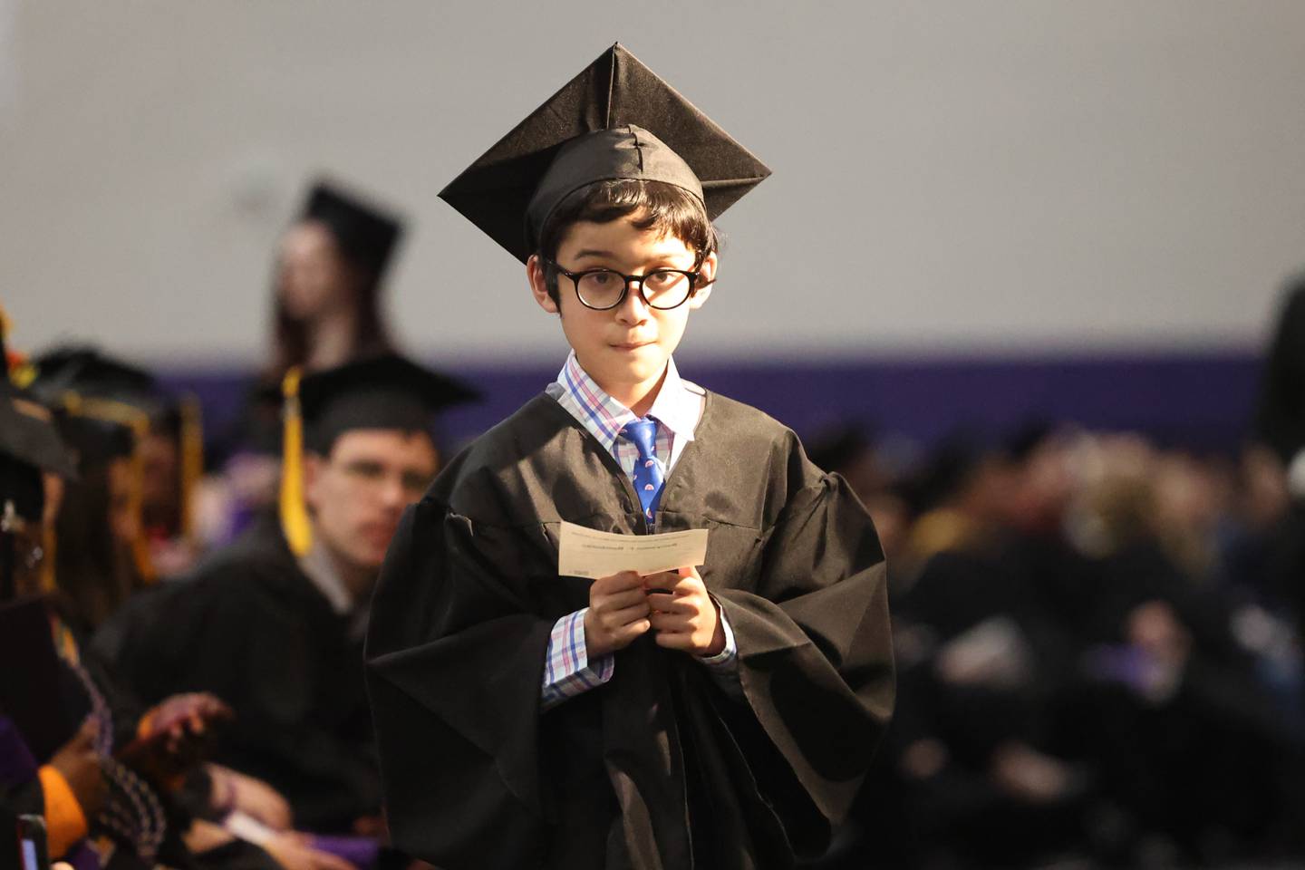 Benyamin Bamburc head to the stage to receive his Associate in Arts Degree at the Joliet Junior College Commencement Ceremony on Friday, May 19, 2023, in Joliet.