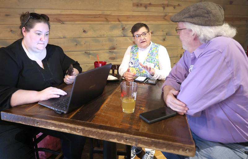 Kori Rempfer, (left) chair of the DeKalb County Democratic Party, Shell DeYoung Dunn, candidate for County Board District 11, and Stewart Ogilvie, candidate for County Board District 4, wait for election returns to start coming in Tuesday, June 28, 2022, during a Democrat candidate watch party at Fatty's Pub and Grille in DeKalb.