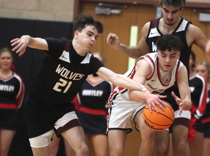 Huntley’s Christian Wilson, right, battles Prairie Ridge’s Brendan Beu in varsity boys basketball on Tuesday, Feb. 18, 2025, at  Huntley High School in Huntley.