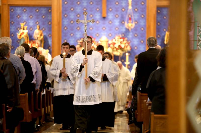 Celebrants exit St. Peter Catholic Church in Geneva following the Mass of Christian Burial for Reverend Jonathan Bakkelund on Wednesday, Jan. 31, 2024.