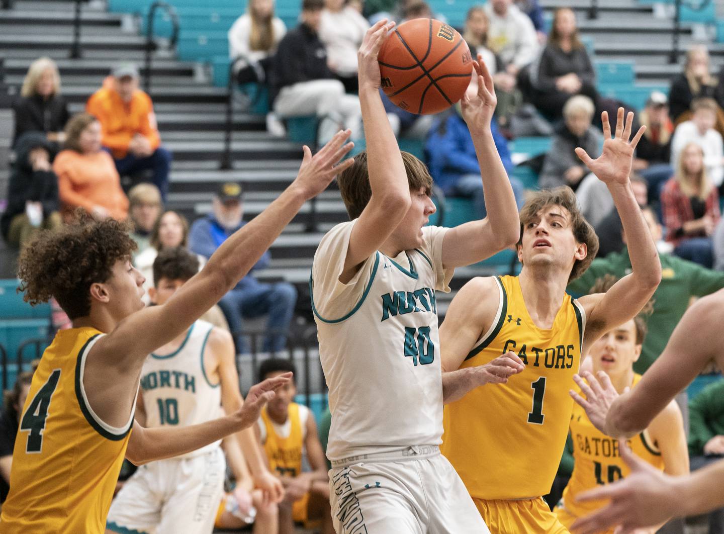 Woodstock North's Tyler Ward looks to pass around Crystal Lake South defenders Anthony Demirov, left, and Zachary Peltz during their game on Saturday, January 7, 2023 at Woodstock North High School. Crystal Lake South won 65-42.  Ryan Rayburn for Shaw Local