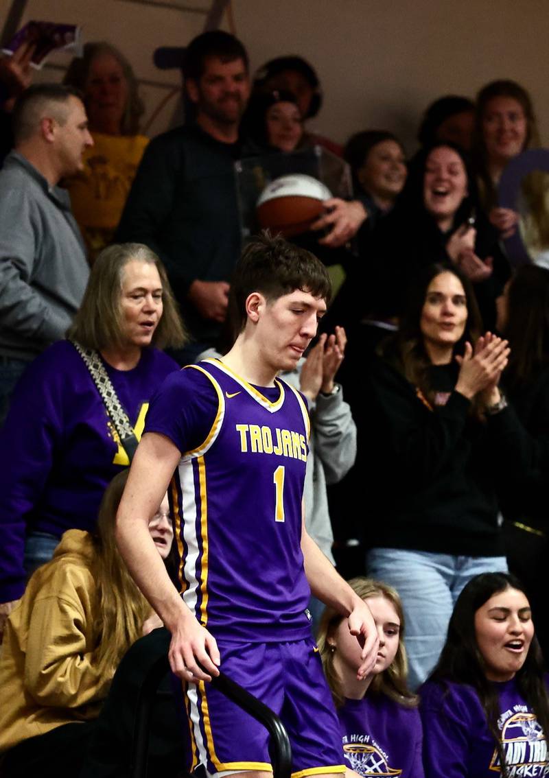 Mendota's Cole Tillman carries a basketball commemorating his 1,000th career point in Friday's game at Princeton.