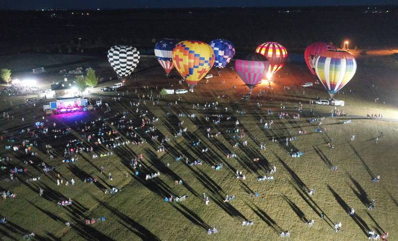 Hot air balloons glow at Zearing Park during the 52nd annual Homestead Festival on Saturday, Sept. 9 2023 in Princeton.