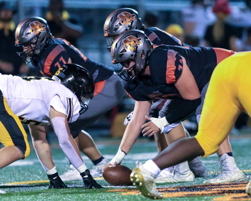 Minooka's Ryan Susnar (72) looks over the Joliet West defense before snapping the ball during varsity football game between Joliet West at Minooka.  Sept 2, 2022