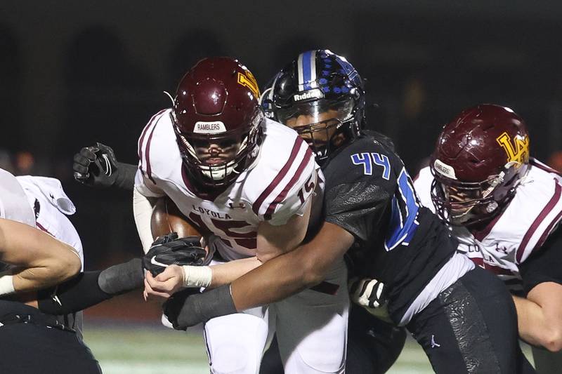 Lincoln-Way East’s Jacob Alexander wraps up Loyola’s Ryan Fitzgerald in the Class 8A semifinal on Saturday, Nov. 23, 2024 in Frankfort.