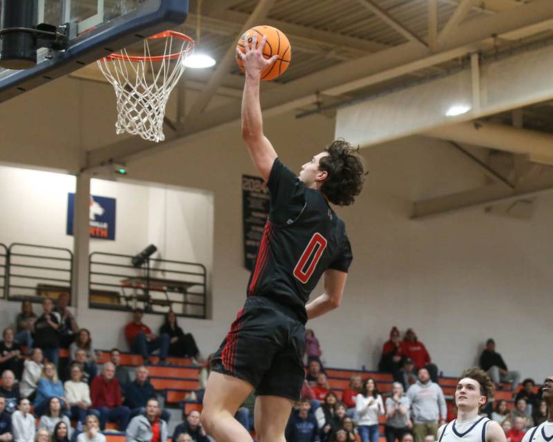 Yorkville's Gabe Sanders (0) goes in for a layup during their Class 4A Naperville North Regional final basketball game between Yorkville at Downers Grove South, Feb 27, 2026 in Naperville.