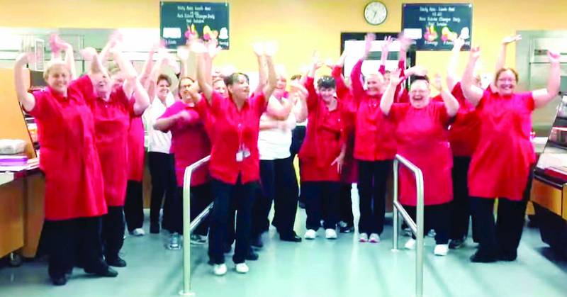 Cafeteria workers are seen dancing in this screenshot from the back-to-school video put together at Grant Community High School.