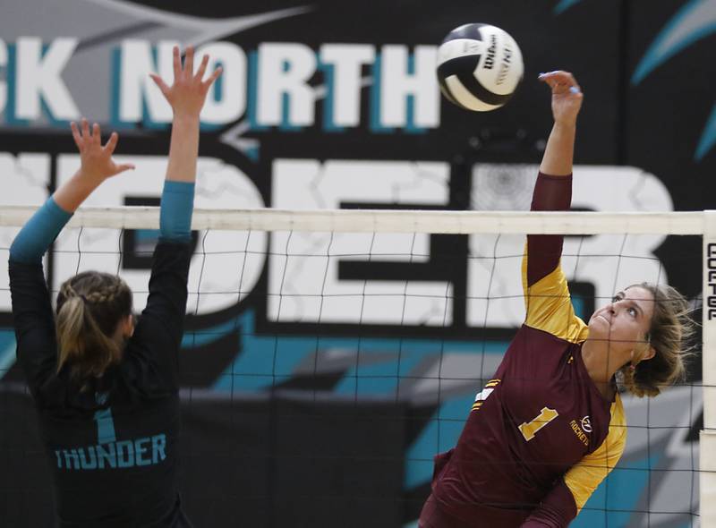 Richmond-Burton's Sophia Komar (right) hits the ball as Woodstock North's Tayler Menzel tries to block during a Kishwaukee River Conference volleyball match on Monday, Sept. 15, 2025, at the Woodstock North High School.