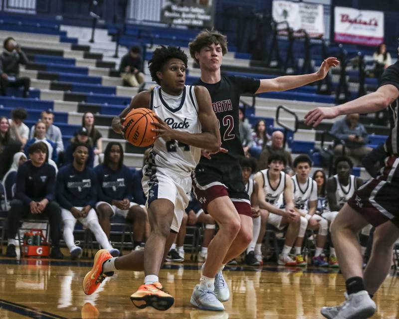 Oswego East's Dshaun Bolden (24) drives baseline during their basketball game between Plainfield North at Oswego East Friday, Dec 5, 2025 in Oswego.