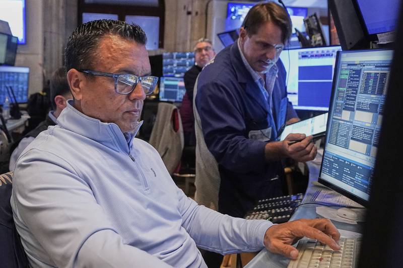 Traders Robert Finnerty Jr., left, and Michael Milano work on the floor of the New York Stock Exchange, Tuesday, July 29, 2025.