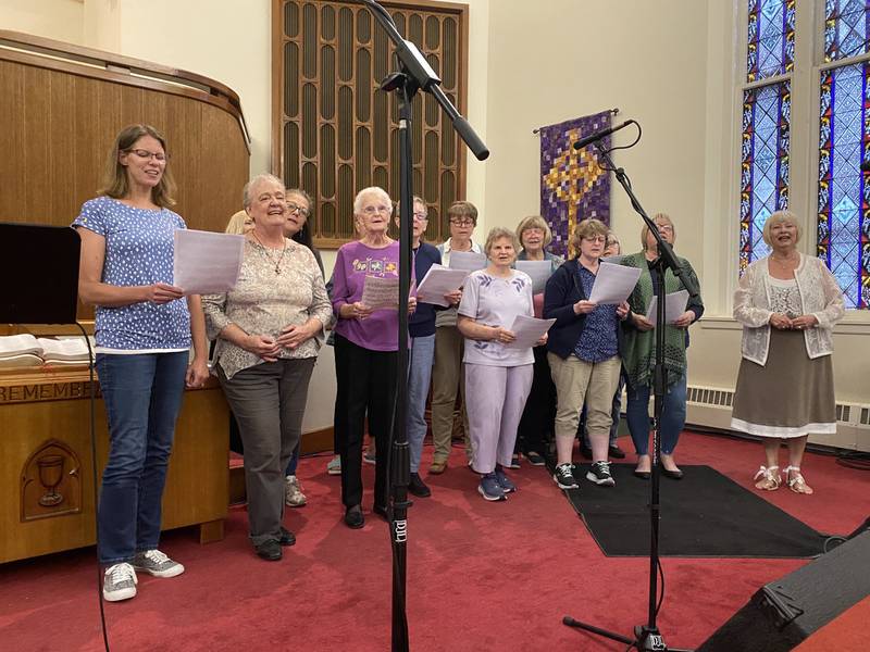 The congregation at Ottawa's Praise in the Park moved indoors after some rain Friday, June 10, 2022, to First Presbyterian Church to sing “Our God is an Awesome God” together with Brent and Michelle Mitchell.