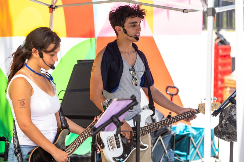 Rachel Vegan, left, and Noah Vega perform with the band Double Helix during Make Music Wheaton and the Wheaton French Market in The Wheaton French Market Plaza on Saturday, June 21, 2025.