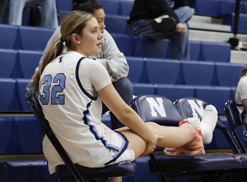 Nazareth's Stella Sakalas (32) watches from the bench after getting injured during the girls varsity basketball game between Bolingbrook high school and Nazareth Academy on Monday, Jan. 12, 2026 in La Grange Park.