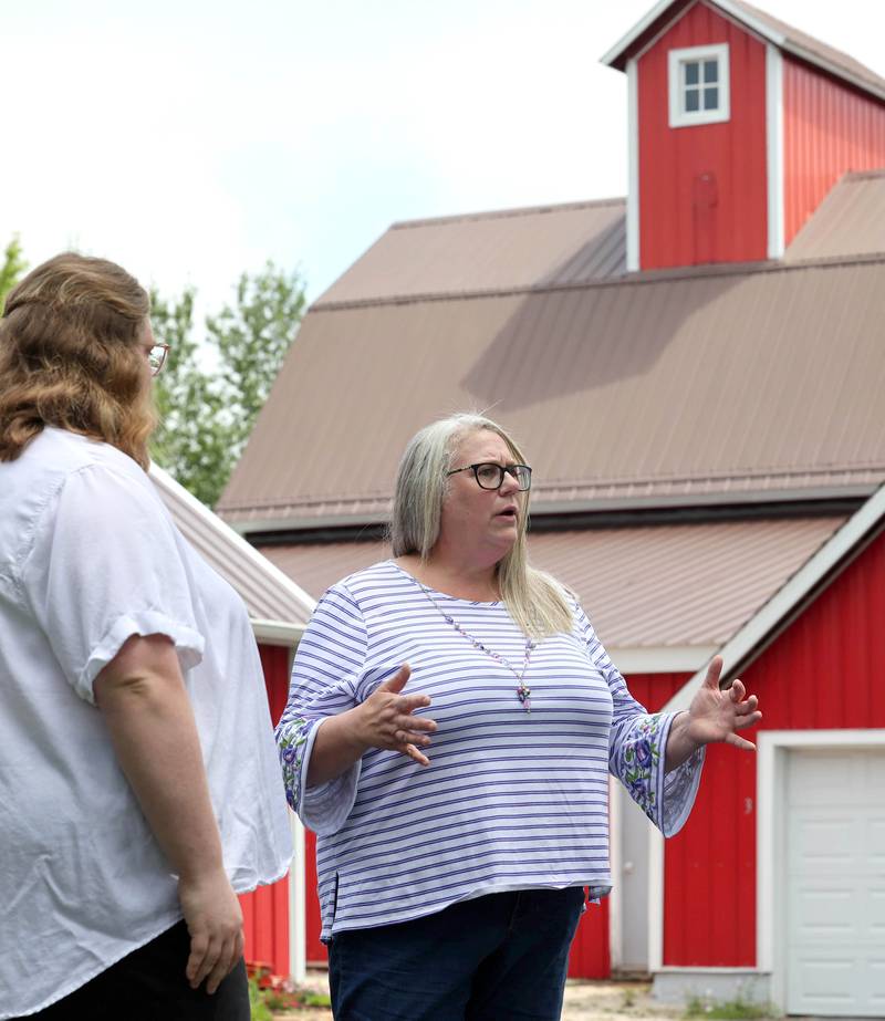 Tammy McMahan, (right) founder and executive director of the Ruth Project, along with her daughter Ashley, storehouse manager with the group, talk Thursday, July 13, 2023, at the organization’s 33-acre farm in Sycamore. The Ruth Project is a group based in Elgin that provides support for foster parents and children.
