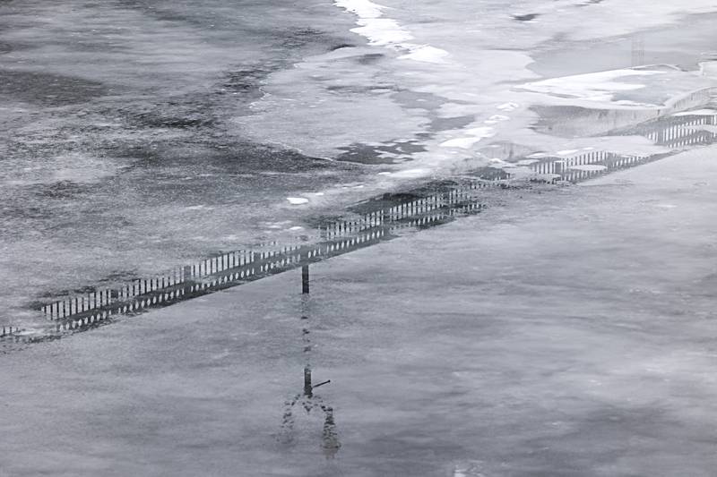 The Peoria Avenue bridge is reflected in the melting ice of the Rock River Tuesday, Jan. 23, 2024. Temps will hover around freezing for the next several days with rain chances on Wednesday and Thursday.