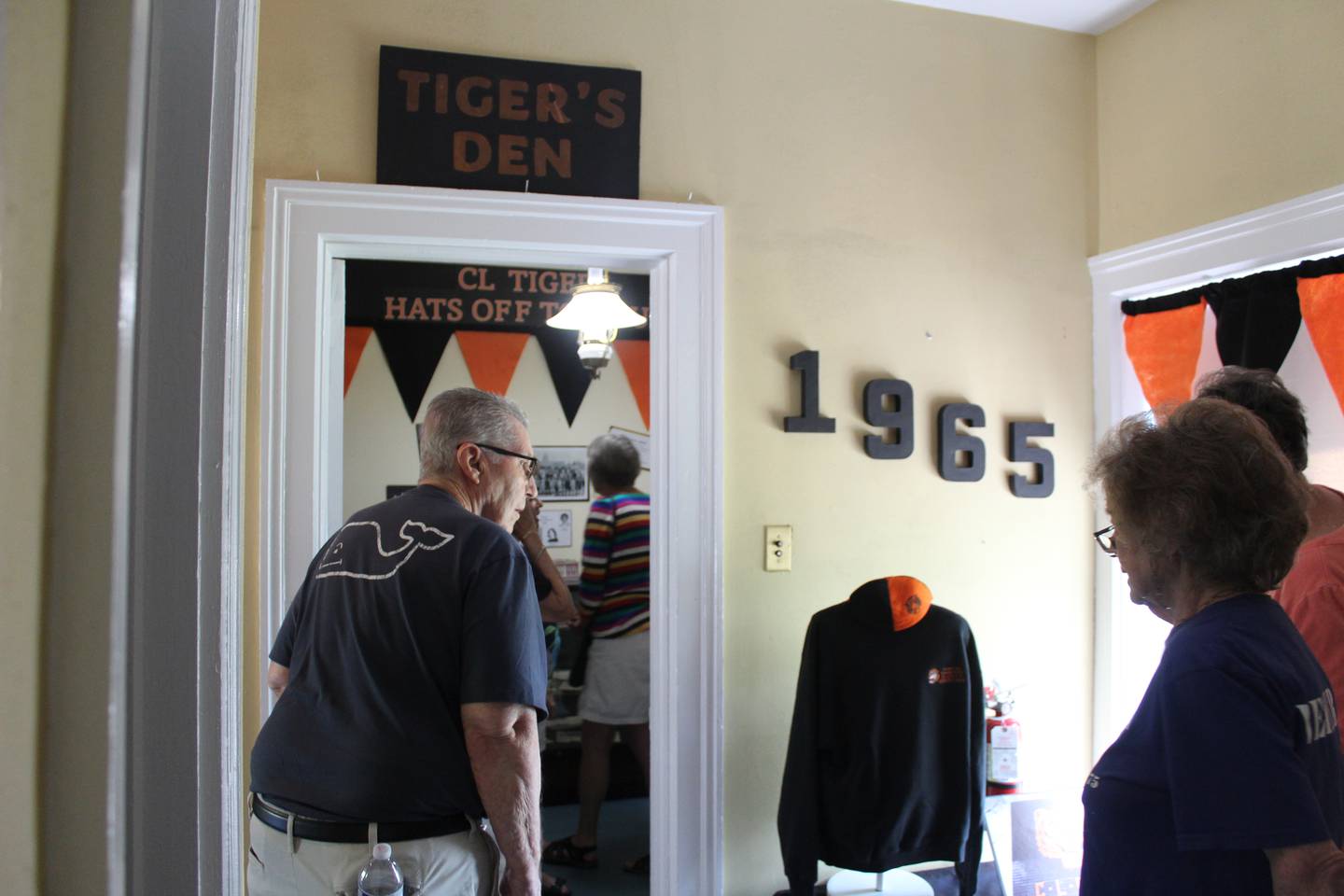 Crystal Lake Central High School class of 1965 alumni look through the Crystal Lake Historical Society's exhibit on Aug. 9, 2025 at the Colonel Palmer House.