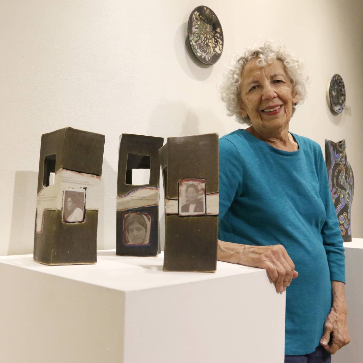 McHenry County College student Elaine Kadakia, 83, with some of her ceramic activist art being exhibited Thursday Sept. 8, 2022, at the gallery at the college.