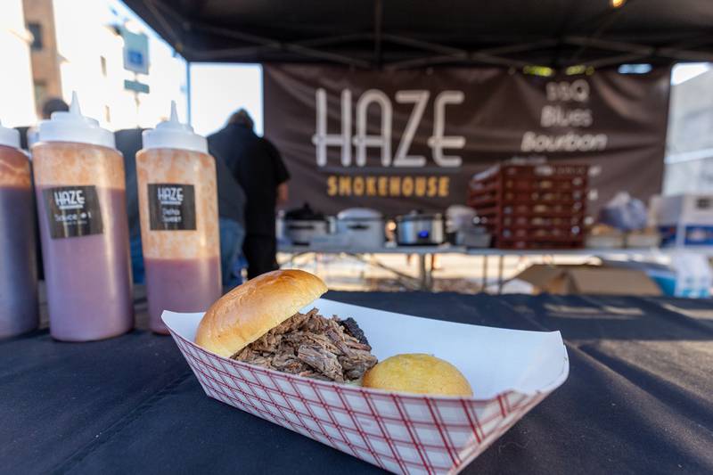Smoked Brisket sandwich and cornbread muffin sit on table of Haze Smokehouse's food stand at the BBQ & Blues Fest on Saturday, Sept. 12, 2025 on First Street in La Salle.