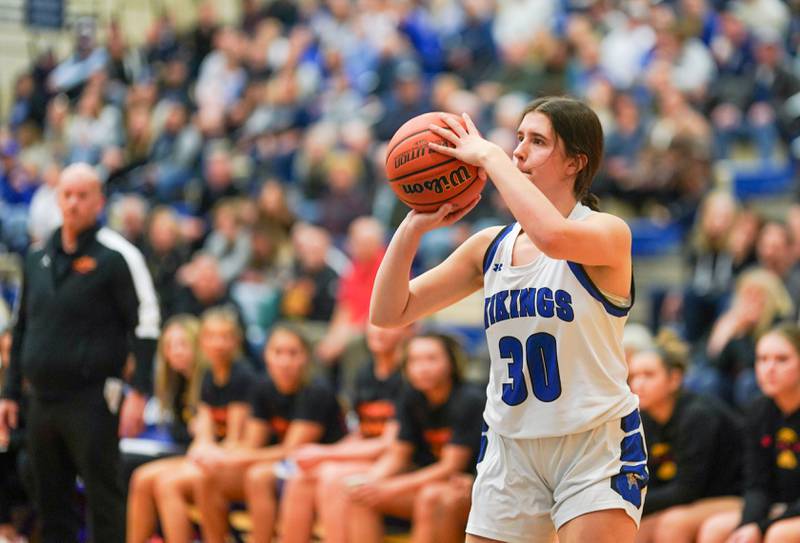 Geneva’s Keira McCann (30) spots up for a three pointer against Batavia during a basketball game at Geneva High School on Friday, Dec 15, 2023.