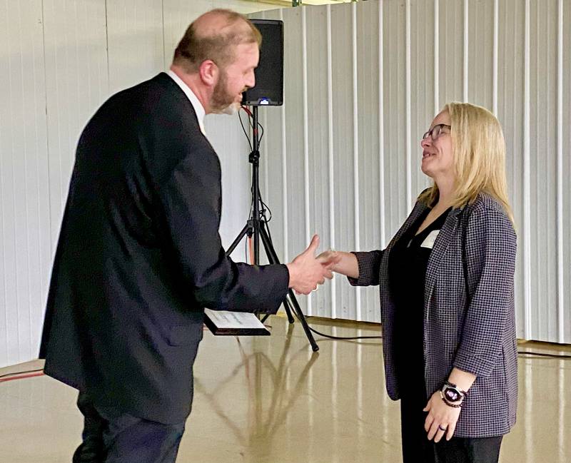 The Rev. Eric Groce (left), of Gospel Life Bible Church, presents Tynisha Clegg, executive director of Family Service Agency of DeKalb County, with the 2024 Excellence in Nonprofit Award on Thursday, Feb. 13, 2025, at the chamber's 68th Annual Meeting and Awards Dinner at Custom Aluminum Products, 312 Eureka St., Genoa.