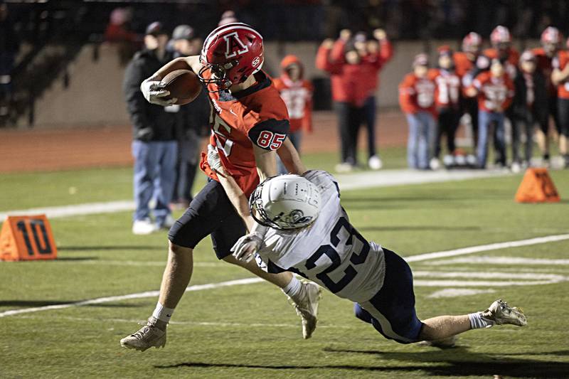Amboy’s Brennan Blain fights for the end zone against Ridgewood’s Preston Moriarity for a TD during the I8FA championship Friday, Nov.17, 2023 at Monmouth College