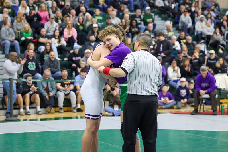 After losing to Wilmington's Logan Van Duyne, left, in the 190-pound championship match, Seneca's Landen Venecia wears a shirt honoring the late Wilmington wrestling coach Nick Dziuban as the two shake hands during the IHSA Class 1A Coal City Sectional on Saturday, Feb. 14, 2026.