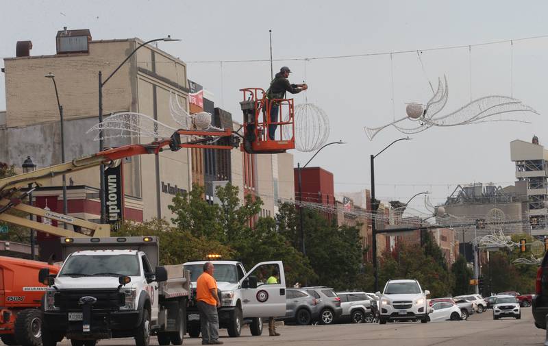 Crews with the City of La Salle, hang Christmas decorations above First Street on Thursday, Oct. 16, 2025 downtown La Salle. The inaugural Frosty on First event is schedule for Nov. 7-8, 2025 downtown La Salle. The festival will feature an ice skating rink with rental skates, an inflatable snowman bounce house, an inflatable maze and a Snow-Zilla slide.