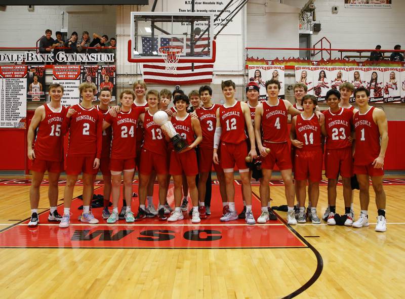 Hinsdale Central poses with the championship trophy after winning the Hinsdale Central Holiday Classic against Oswego East high school on Thursday, Dec. 29, 2022 in Hinsdale, IL.