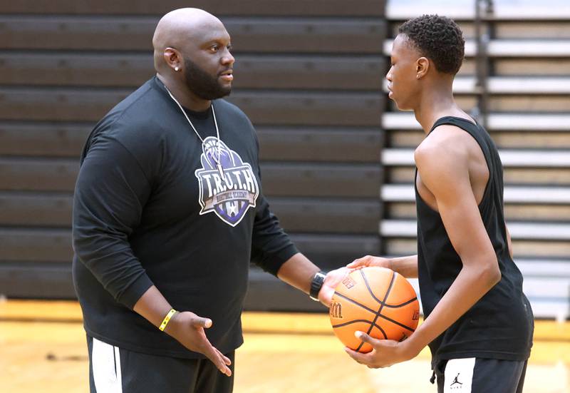 Jay Moore, founder of TRUTH Basketball Academy and an assistant basketball coach at DeKalb High School, gives some instruction to DeKalb sophomore Gabe Crump, 15, Tuesday, June 25, 2024, during a session at the school.