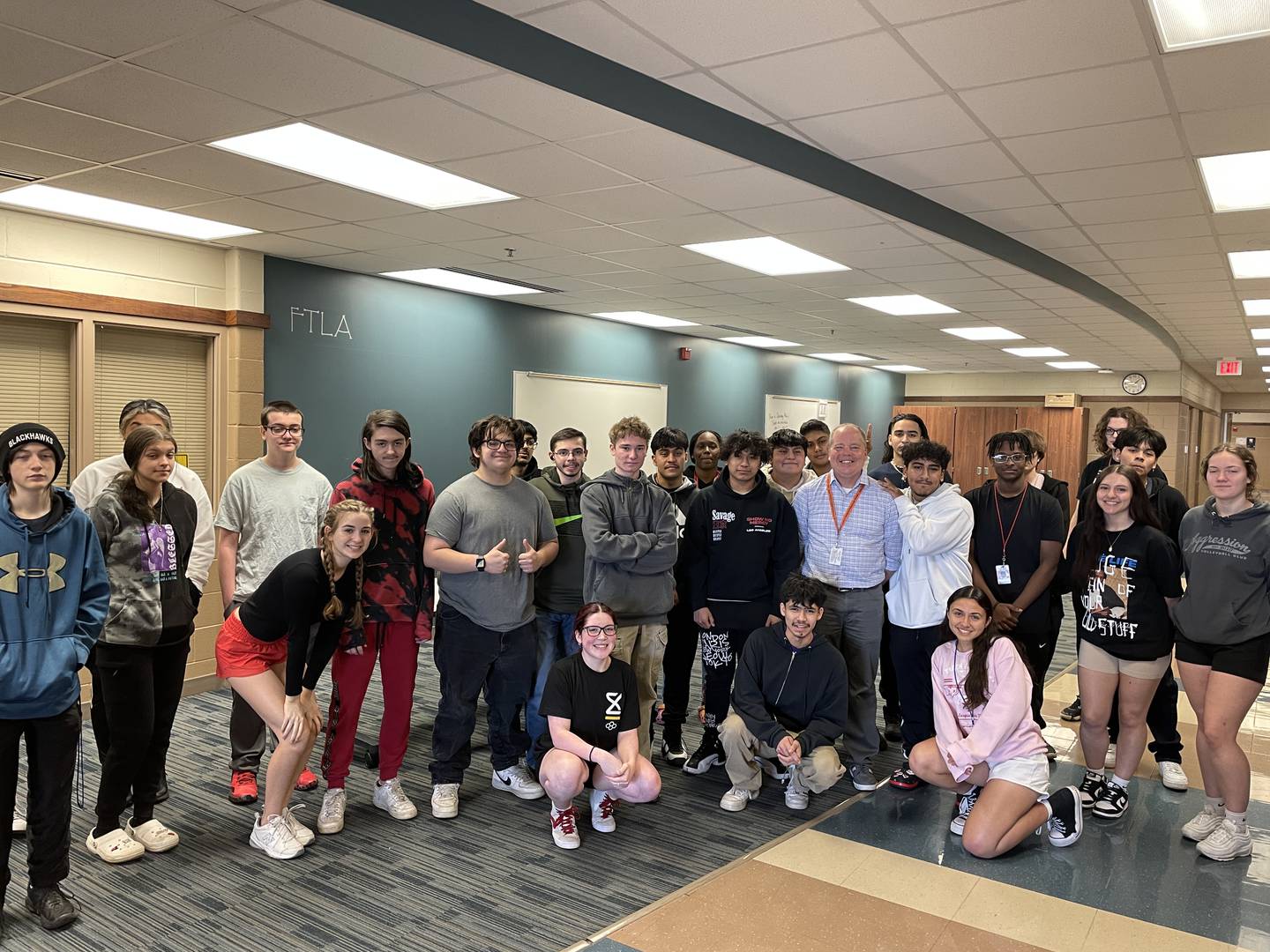 Greg Solomon, DeKalb High School humanities teacher and recipient 2023 Wirtz Award Excellence in Teaching, poses with his students.