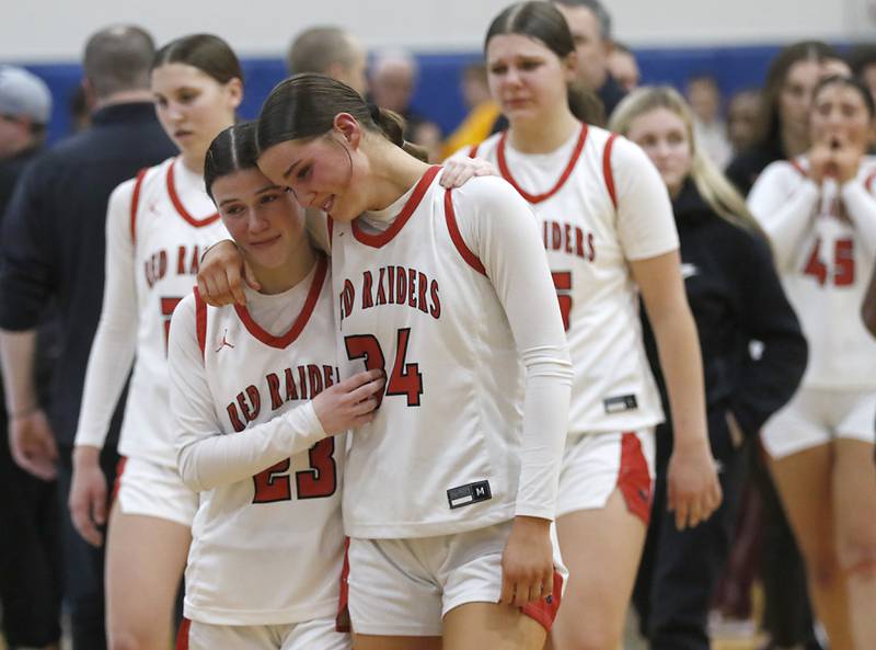 Huntley's Aubrina Adamik and Ava Mcfadden  hug after Huntley was defeated by Loyola Academy in the IHSA Class 4A Gurnee Warren Supersectional girls basketball game on Monday, March 3, 2025, at Warren Township High School in Gurnee.