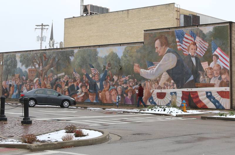 Snow falls next to the Lincoln Douglas mural on Tuesday, Nov. 15, 2022 in Ottawa.