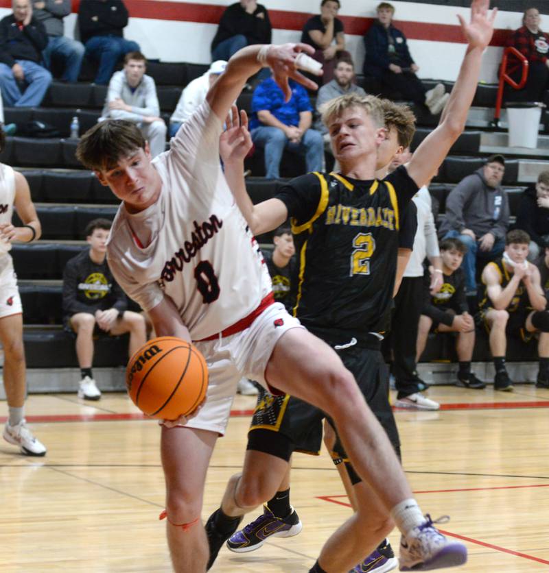 Forreston's Brandon Greenfield (0) and Riverdale's Jackson Tegeler (2) fight for a rebound on Friday, Dec. 27, 2024 at the Cliff Warkins Memorial Basketball Tournament at Erie High School.