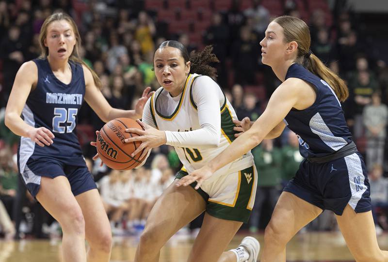 Waubonsie Valley’s Danyella Mporokoso drives to the hoop against Nazareth Academy’s Jane Manecke Friday, March 1, 2024 in the girls basketball 4A state semifinal at CEFCU Arena in Normal.