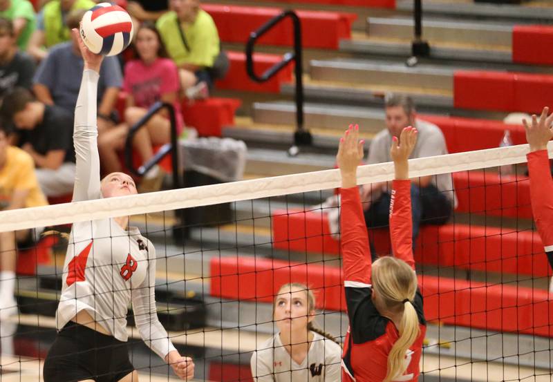 Woodland's Grace Longmire spikes the ball past Earlville's Jessie Miller on Wednesday, Sept. 25, 2024 at Woodland High School.