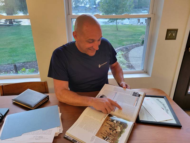 Shannon Anderson points to a paragraph in a history textbook that describes the mission he took part in while serving in the U.S. Marine Corps. His unit's humanitarian mission in Iraq never made news headlines, so he finds the mention particularly special.