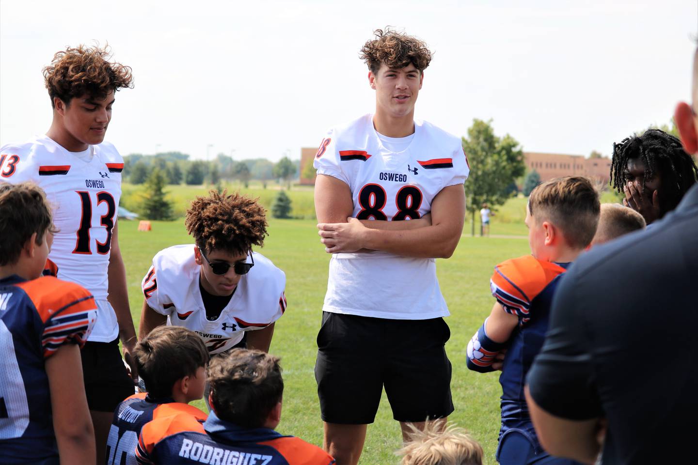Players from the Oswego High School varsity football team attended an Oswego Youth Tackle Football game to support and encourage a 9U team on Sept. 17 2022.
