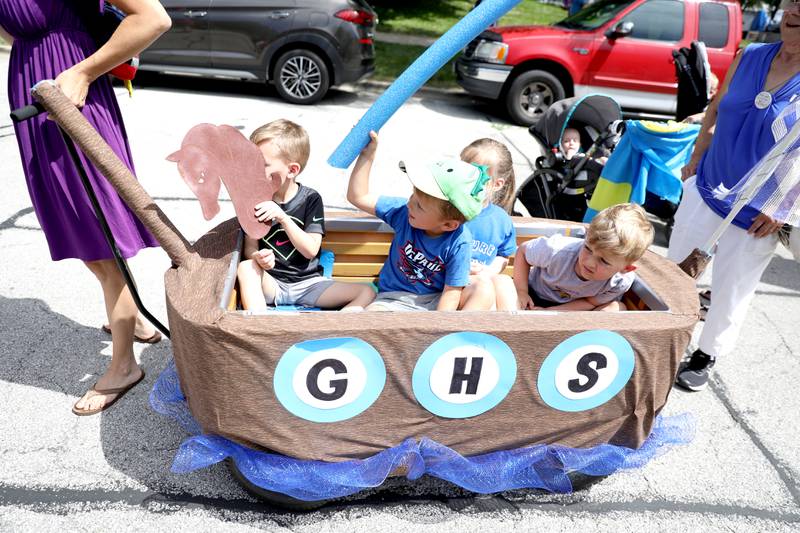 (From left) Sawyer Swentik, 4, Max Haiduk, 4, Emmy Cornick, 3, and Niall Murphy, 4, ride in a viking ship during the Swedish Days Kids’ Day Parade in Geneva on Friday, June 24, 2022.