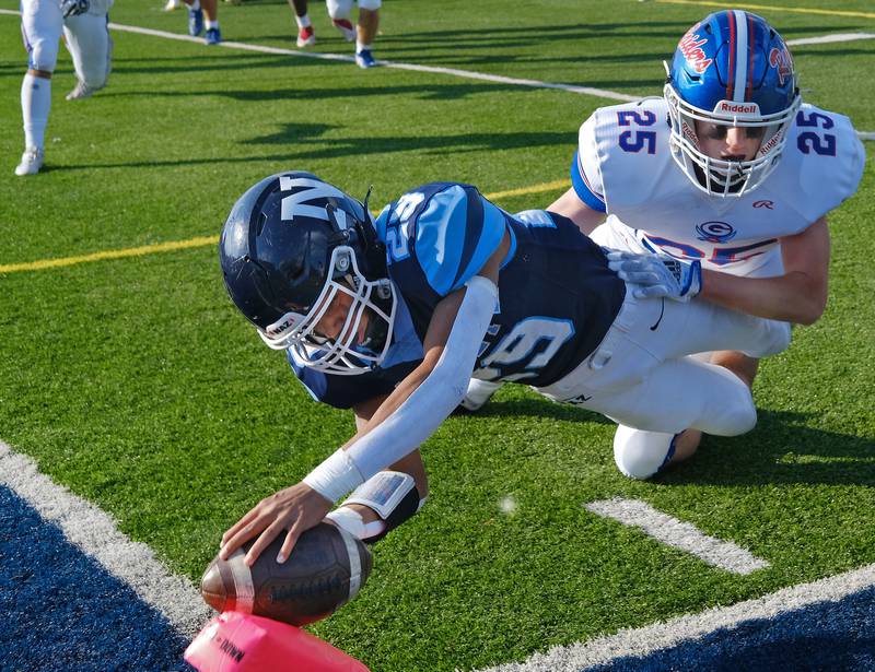 Nazareth's Charles Calhoun dives to the pylon for a touchdown as Glenbard South's Thomas Burke (25) defends during a Class 5A second round game on Nov. 4, 2023 at Nazareth Academy in LaGrange Park.