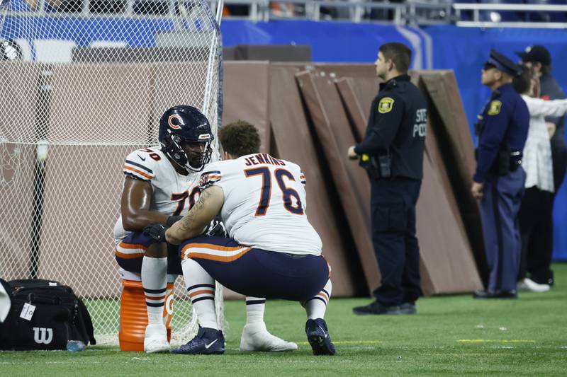 Chicago Bears offensive lineman Teven Jenkins talks to teammate Braxton Jones after the second half against the Detroit Lions, Sunday, Jan. 1, 2023, in Detroit.
