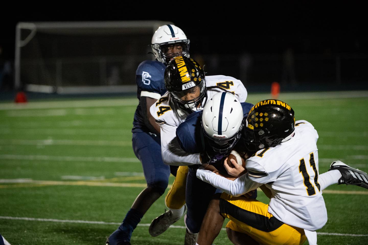 Plainfield South's Cody Hogan is brought down by Joliet West's DaVante Morrow and Sedrick Love during a game  Friday Oct. 4, 2024 at Plainfield South High School