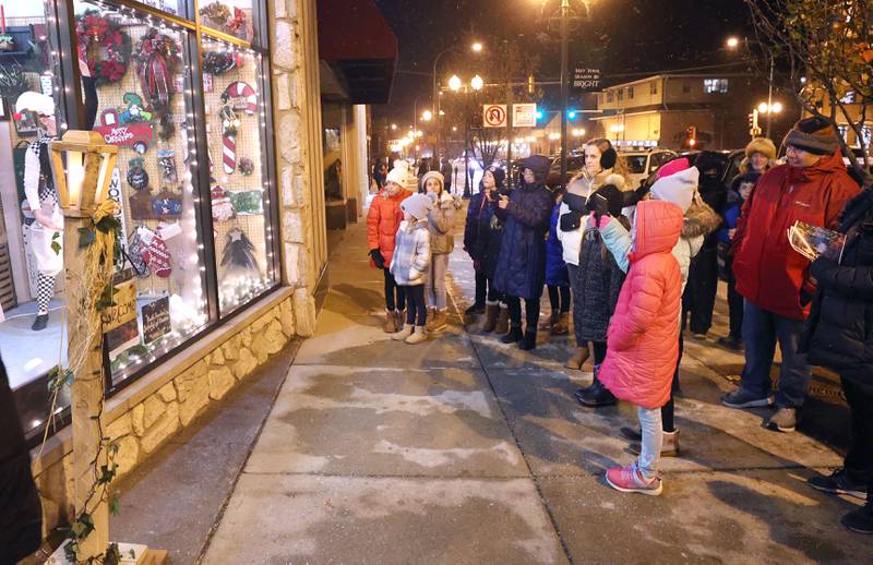Visitors watch a dancer in the window of the store Made Just for You Friday, Nov. 18, 2022, during the Sycamore Chamber of Commerce's annual Moonlight Magic event in downtown Sycamore.