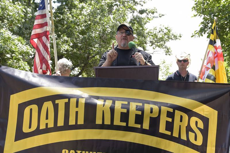 FILE - Stewart Rhodes, founder of the Oath Keepers, center, speaks during a rally outside the White House in Washington, June 25, 2017. A new report says that the names of hundreds of U.S. law enforcement officers, elected officials and military members appear on the leaked membership rolls of a far-right extremist group that's accused of playing a key role in the Jan. 6, 2021, riot at the U.S. Capitol. The Anti-Defamation League Center on Extremism pored over more than 38,000 names on leaked Oath Keepers membership lists to find more than 370 people it believes are currently working in law enforcement agencies.
